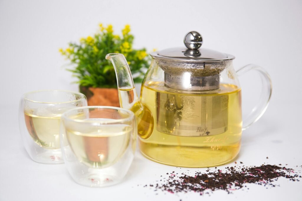 A glass teapot of warming herbal tea, an Ayurvedic immunity-boosting drink perfect for a healthy winter foods diet